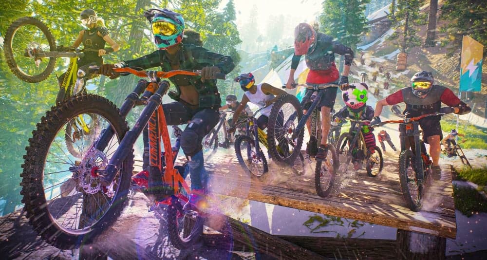 A huge group of cyclists ride down a forest course on BMX bikes via Riders Republic (2021), Ubisoft