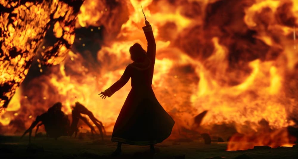 A unseen wizard is silhouetted by fire, along with a spider via Hogwarts Legacy (2022), Warner Bros. Interactive Entertainment
