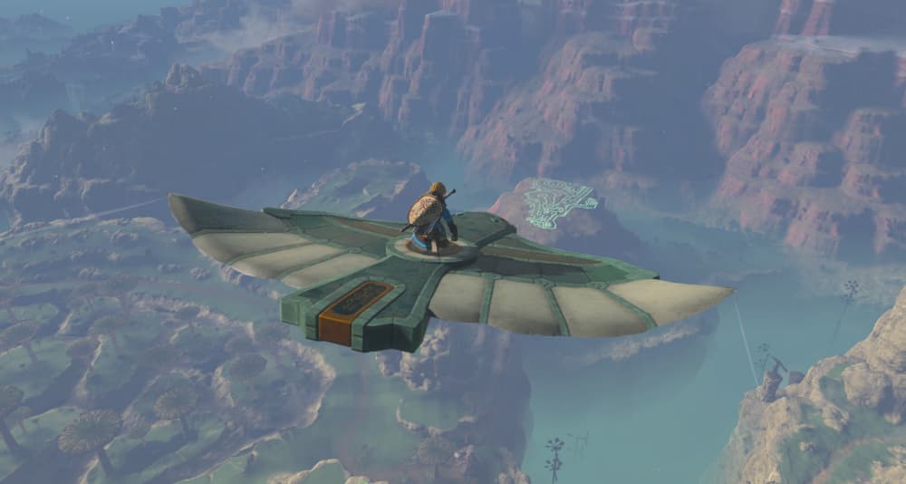 Link soars above the land on a bird statue. The land below shows small windmills, giant mushroom-like trees, and glowing geoglpyhs via The Legend of Zelda: Tears of the Kingdom (2023), Nintendo