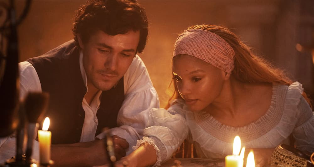 (L-R): Jonah Hauer-King as Prince Eric and Halle Bailey as Ariel in Disney's live-action THE LITTLE MERMAID. Photo by Giles Keyte. © 2023 Disney Enterprises, Inc. All Rights Reserved.