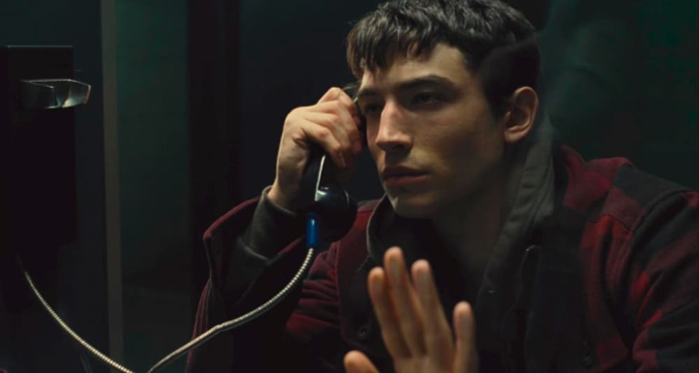 Barry Allen (Ezra Miller) watches father Henry Allen (Billy Crudup) taken to cell in Zack Snyder's