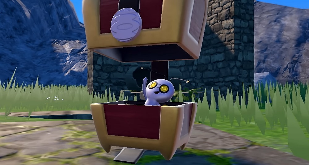A Gimmighoul waves from inside its chest via Pokémon Scarlet & Violet (2022), Nintendo