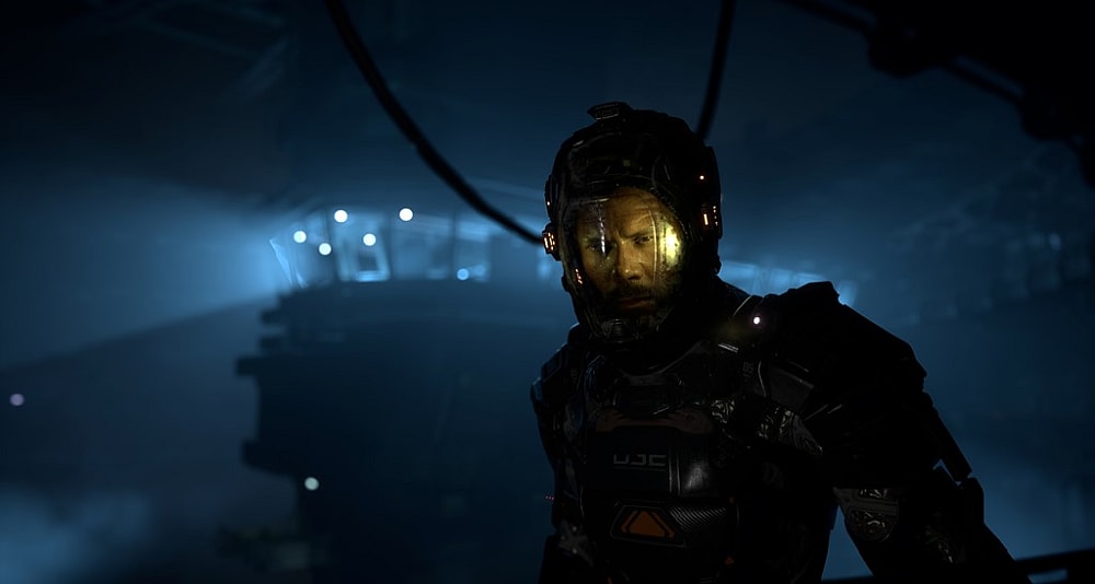 Jacob Lee stands in the Armored Suit in the dark via The Callisto Protocol (2022), Krafton