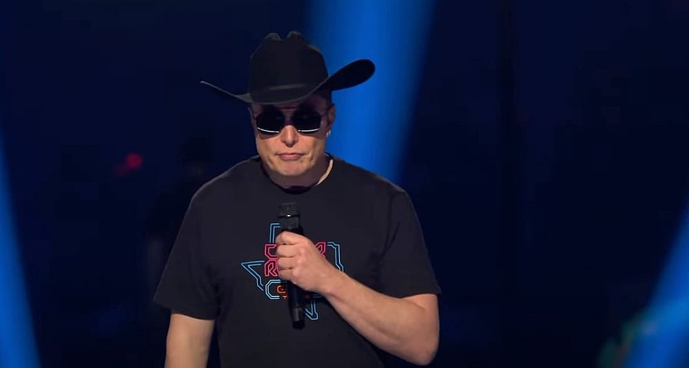 Elon Musk in hat at Tesla