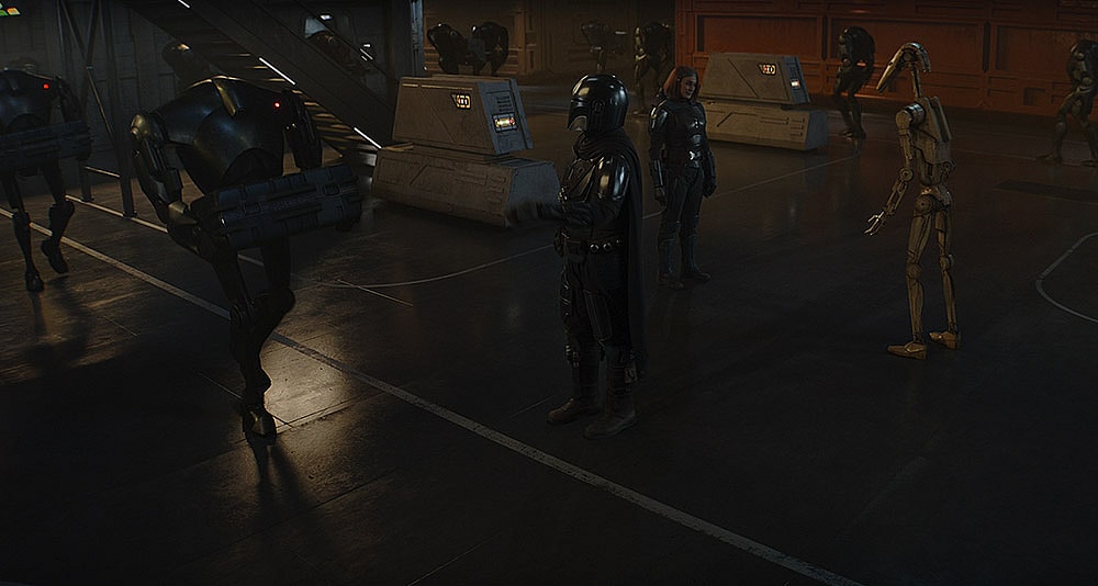 Kryze and Djarin investigate a Droid loading facility in 'The Mandalorian' (2023), Disney+