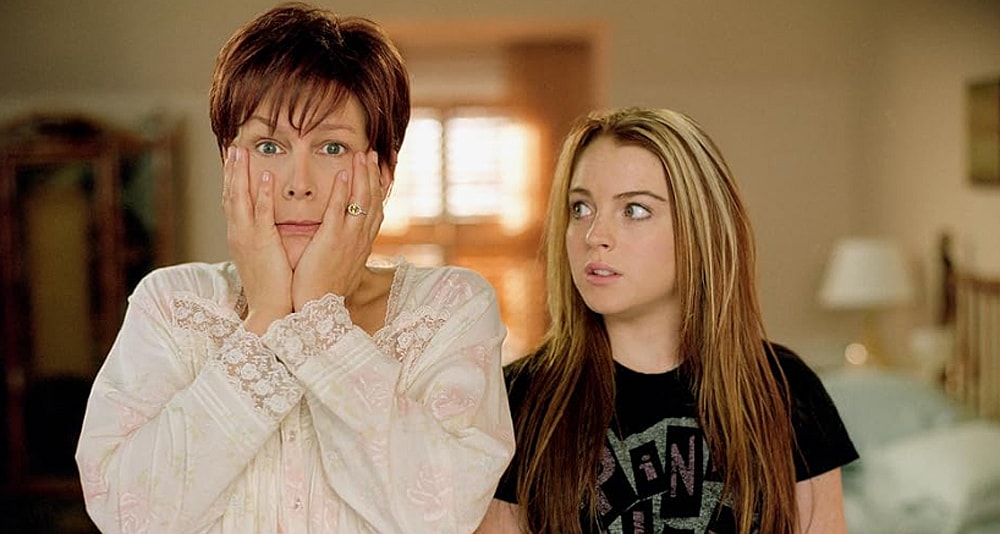 A shocked woman stands next to a teenaged girl.