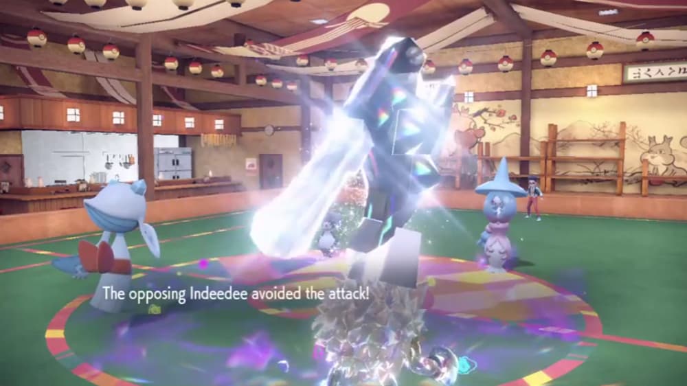 Frosslass' Frost Breath misses against an Indeedee, in a double battle with a Steel Terastallized Primeape and Hatterene via Pokémon Scarlet & Violet (2022), Nintendo