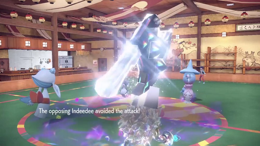 Frosslass' Frost Breath misses against an Indeedee, in a double battle with a Steel Terastallized Primeape and Hatterene via Pokémon Scarlet & Violet (2022), Nintendo