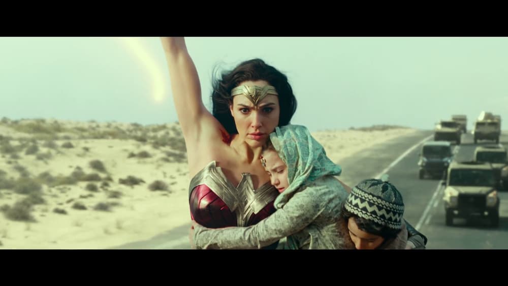 Wonder Woman (Gal Gadot) swings in to rescue two children from an oncoming convoy of armored vehicles in Wonder Woman 1984 (2020), Warner Bros. Pictures via Blu-ray