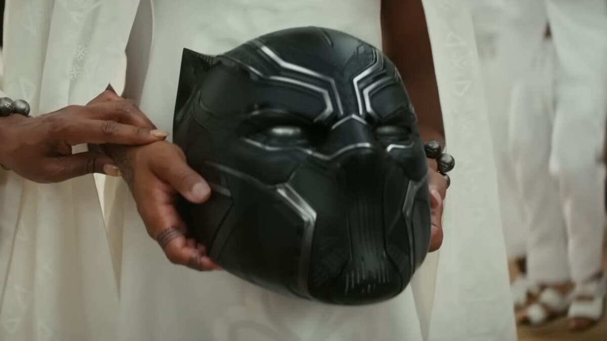 Shuri (Letitia Wright) carries the fallen Black Panther's helmet in Black Panther: Wakanda Forever (2022), Marvel Entertainment