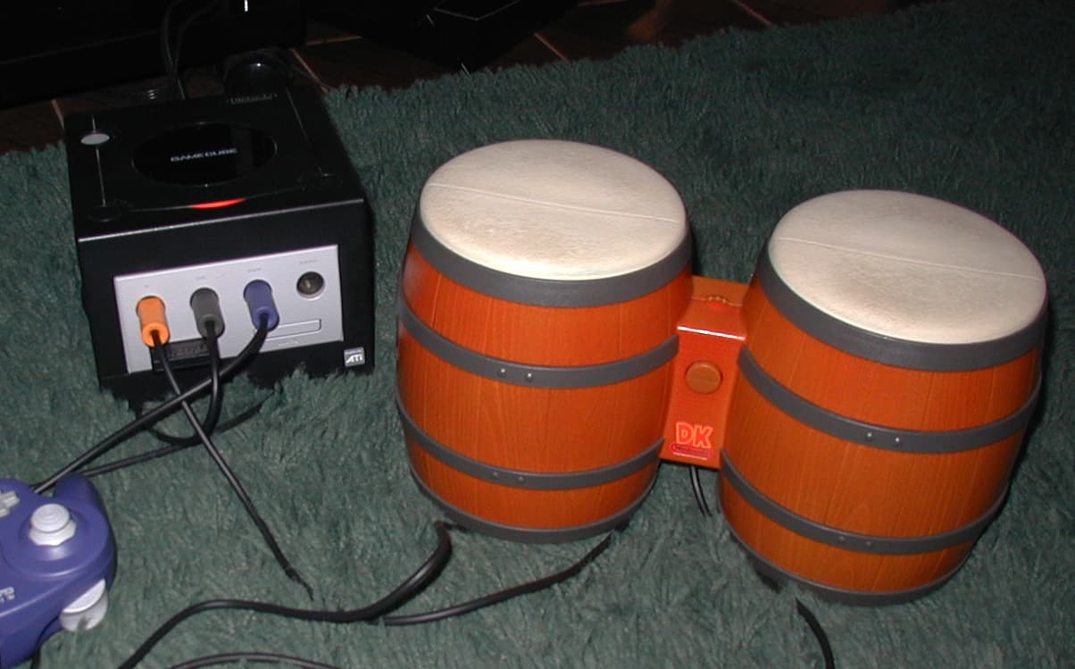 A set of DK Bongos hooked up to a classic purple GameCube. Via Erick Sasse, Wikipedia.