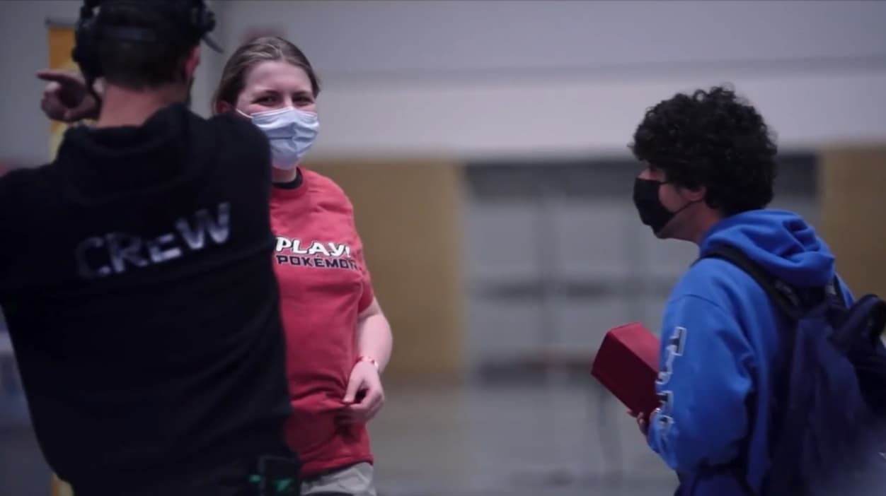 A player and Play! Pokémon staff converse wearing face masks via TCG Day 1 | 2023 Pokémon Charlotte Regional Championships, PokemonTCG Twitch