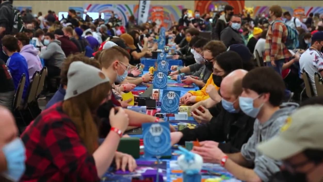 Multiple tables with players playing the Pokémon Trading Card Game wearing face masks via TCG Day 1 | 2023 Pokémon Charlotte Regional Championships, PokemonTCG Twitch