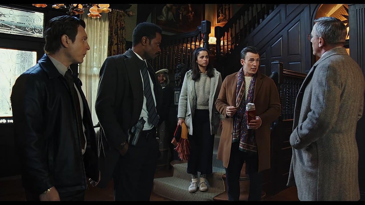 Hugh Ransom Drysdale (Chris Evans) brushes off Benoit Blanc (Daniel Craig) as Marta Cabrera (Ana de Armas), Det. Lt. Elliott (Lakeith Stanfield), and Trooper Wagner (Noah Segan) look on in Knives Out (2019), Lionsgate via YouTube
