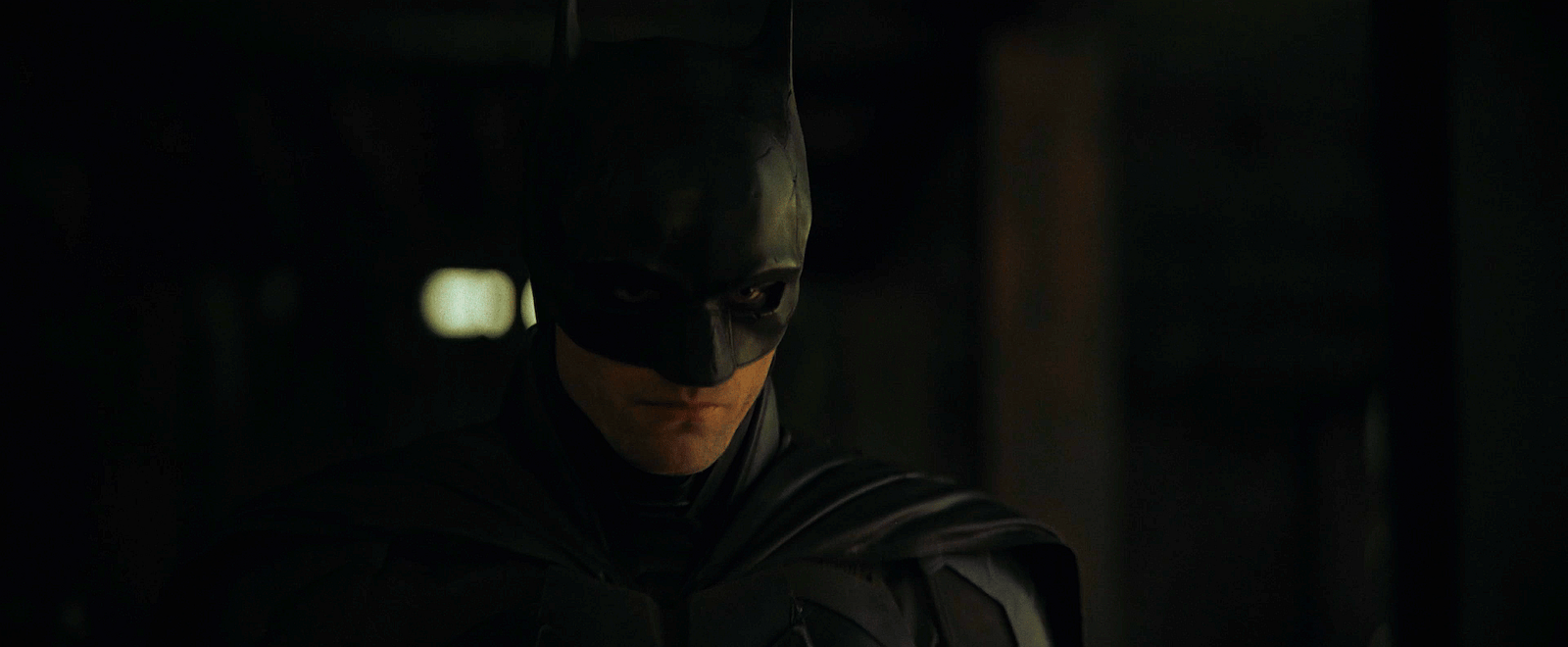 Batman (Robert Pattinson) and Lieutenant Jim Gordon (Jeffrey Wright) interrogate William Kenzie (Peter McDonald) in The Batman (2022) via Warner Bros. Pictures