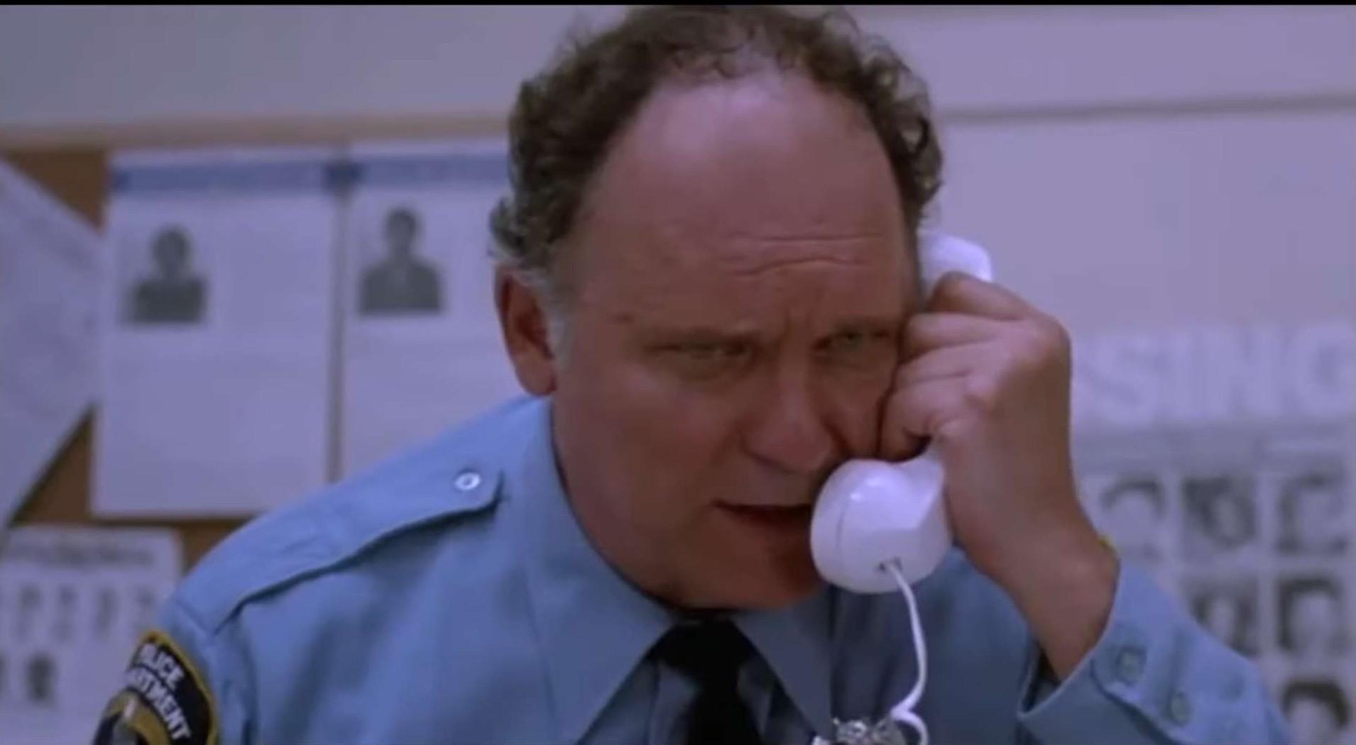 Officer Mooney (John Vernon) is reaching his boiling point with these damn kids, and their pranks in Killer Klowns From Outer Space (1988) Trans World Entertainment 