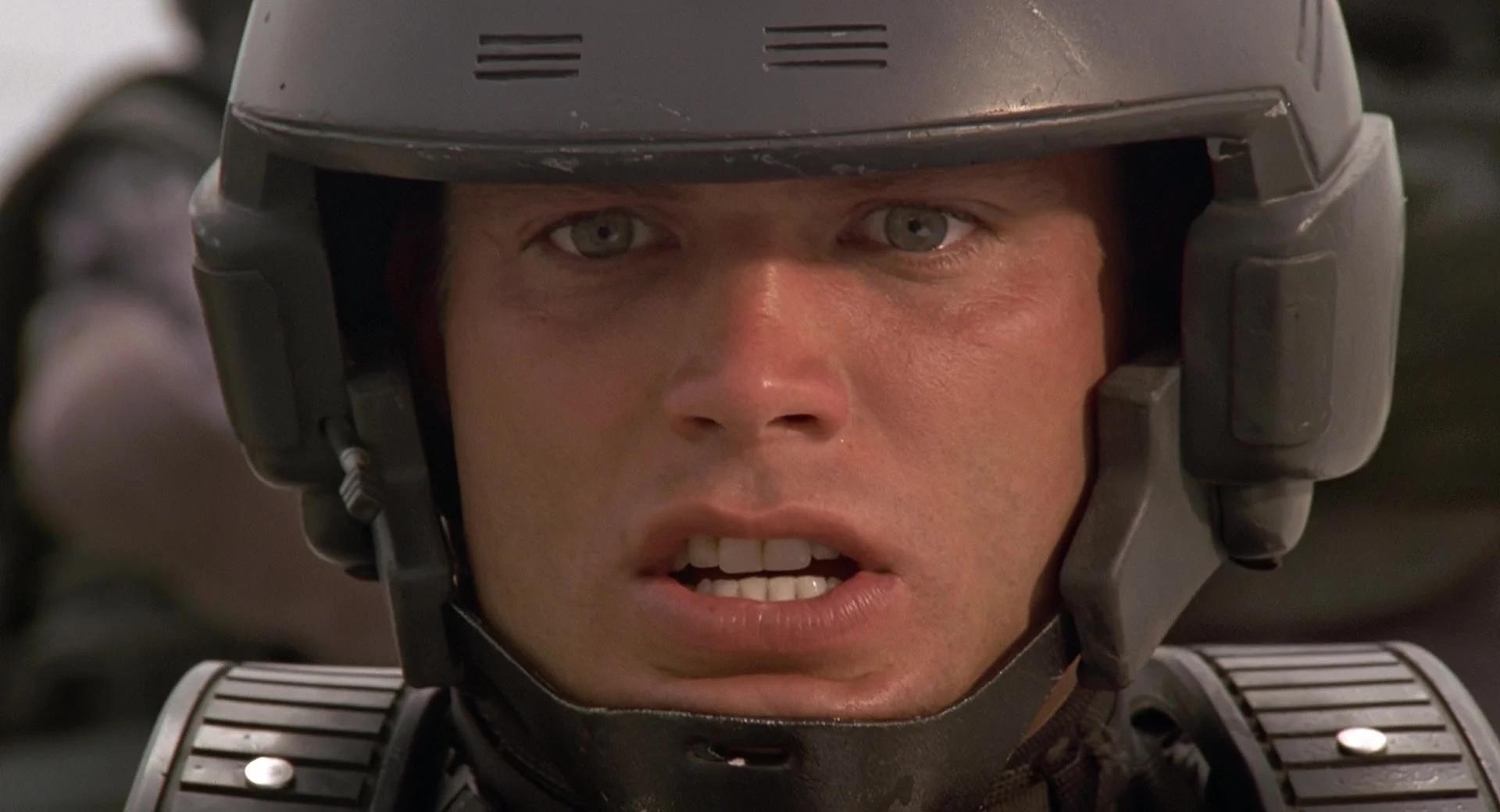 Johnny (Casper Van Dien) realizes his friendly-fire was fatal in Starship Troopers (1997), Tri-Star Pictures