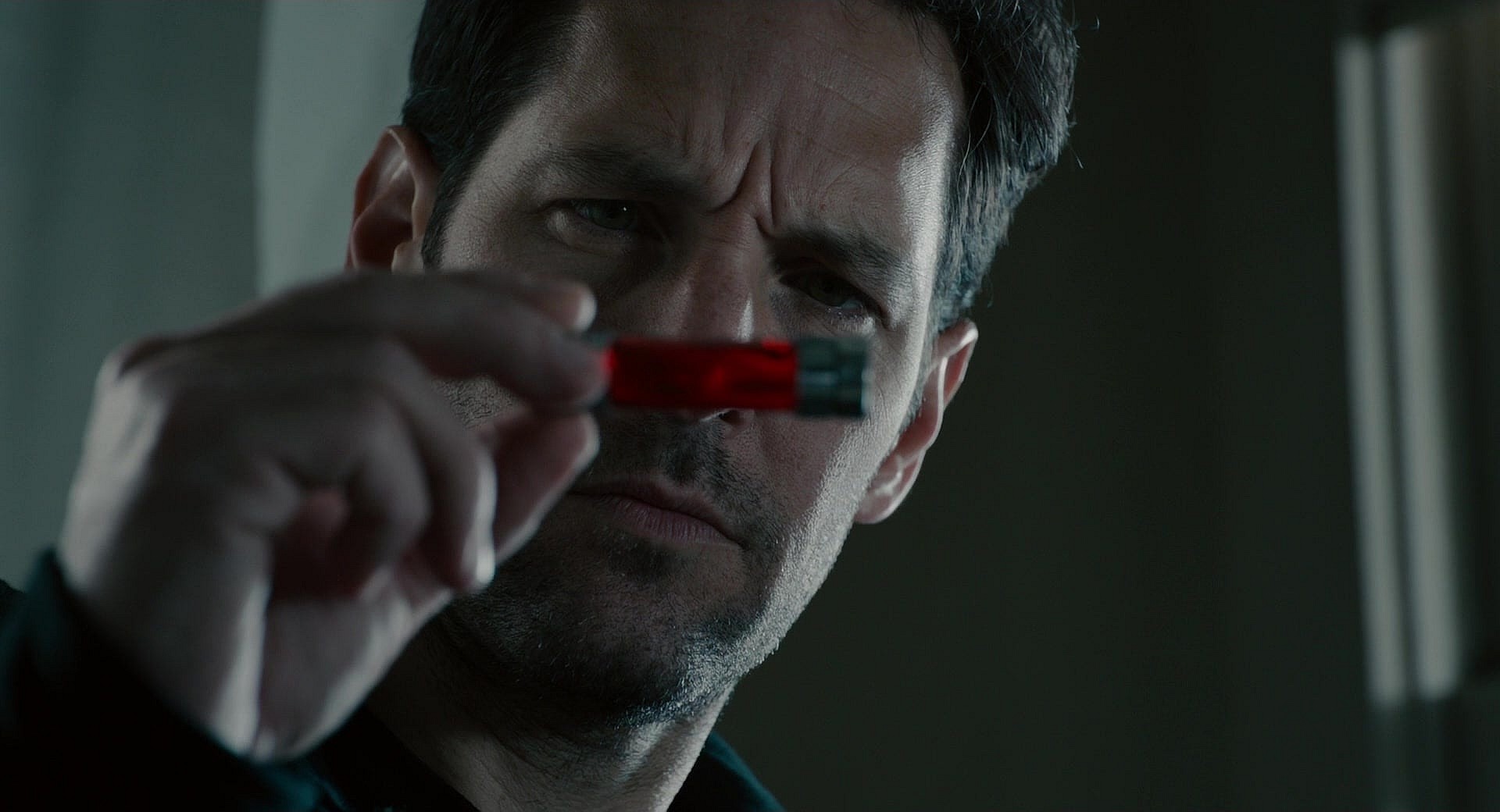 Scott Lang (Paul Rudd) is unsure of what to make of Hank Pym's signature particles in Ant-Man (2015), Marvel Entertainment