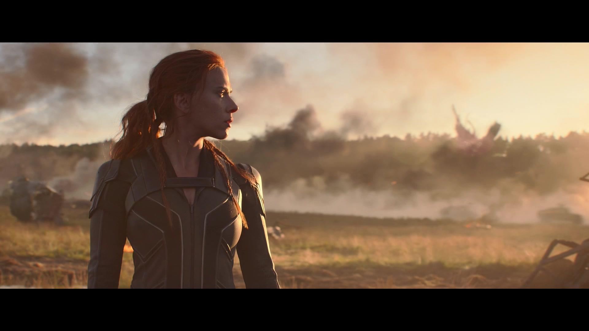 Black Widow (Scarlett Johansson) surveys the wreckage of the Red Room in Black Widow (2021), Marvel Entertainment