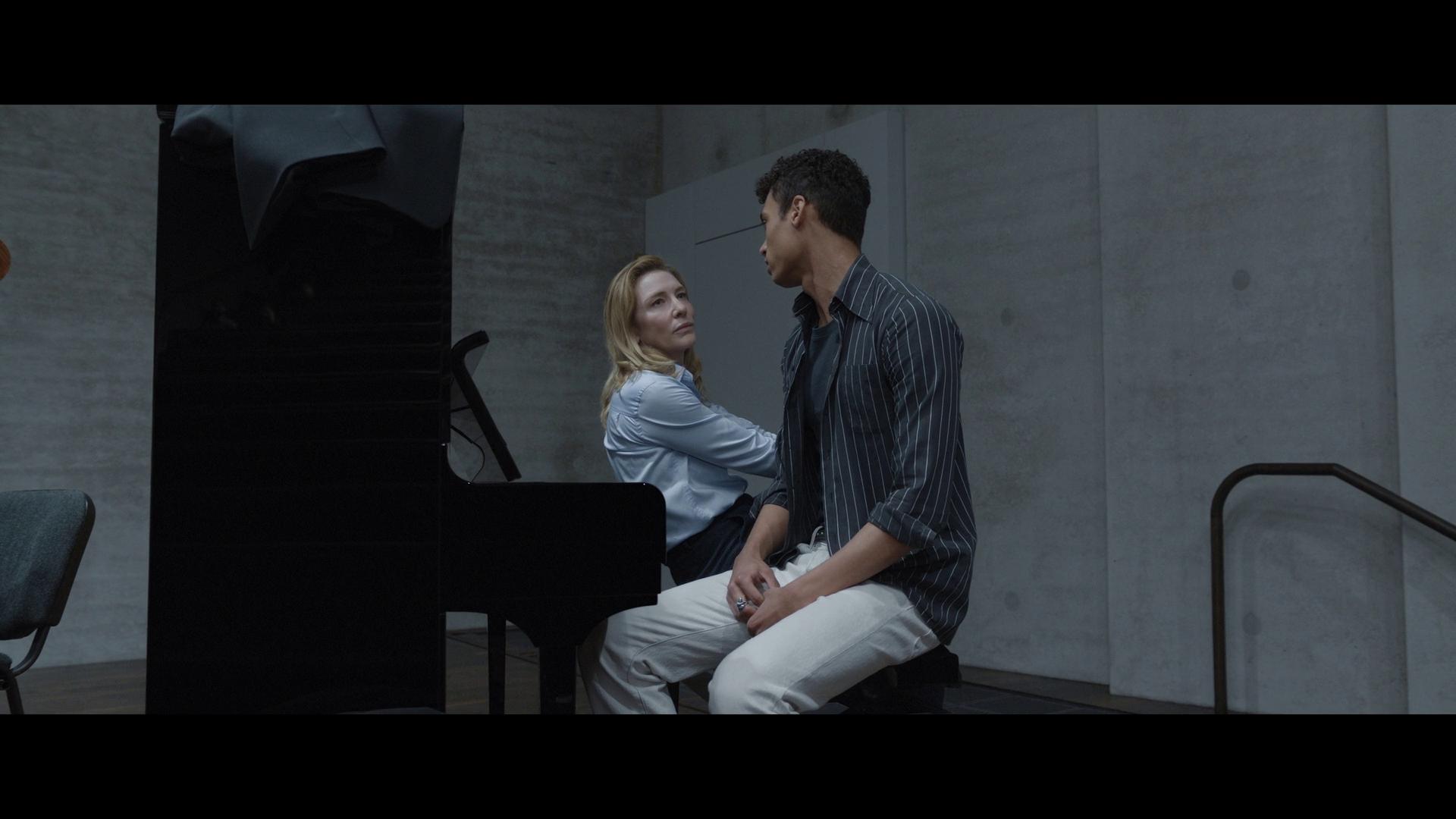 Lydia Tár (Cate Blanchett) pushes back against Max's (Zethphan Smith-Gneist) obsession with identity politics via Tár (2022), Universal Pictures