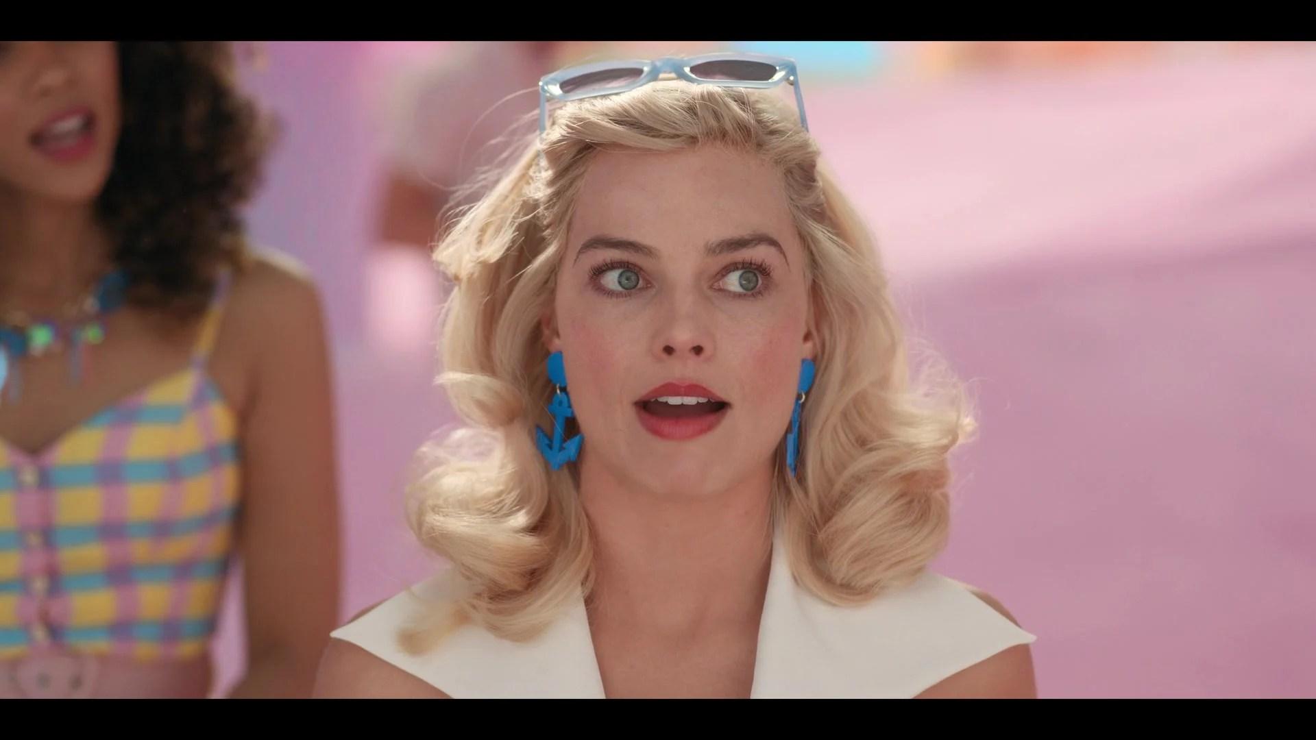 Barbie (Margot Robbie) recounts her recent weirdness in Barbie (2023), Warner Bros. Pictures