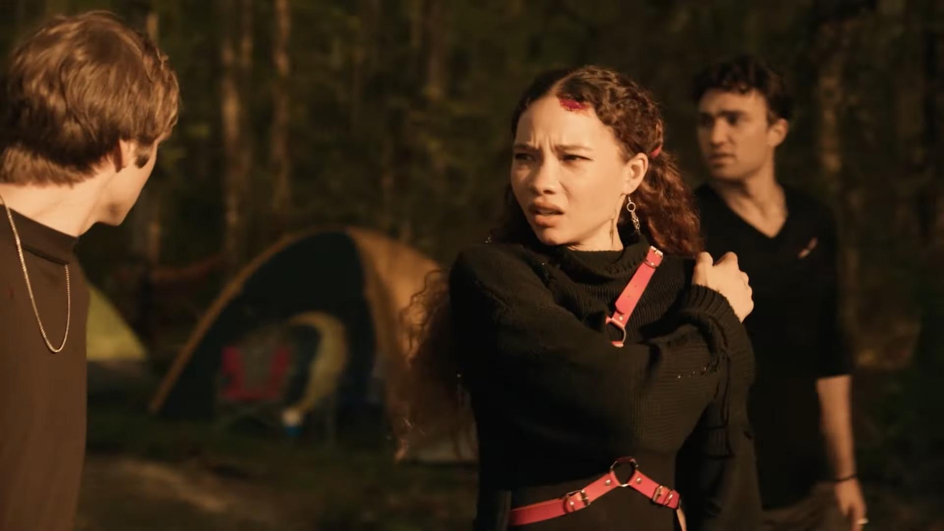 Ash (Ashley Moore) is unnerved by her current surroundings in Festival of the Living Dead (2024), TUBI