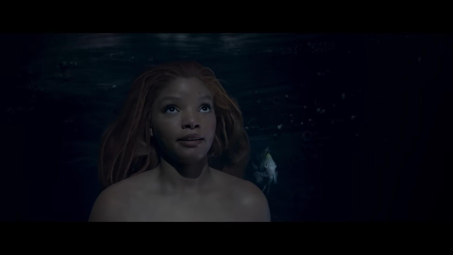 Ariel (Halle Bailey) explains herself to King Triton (Javier Bardem) in The Little Mermaid (2023)