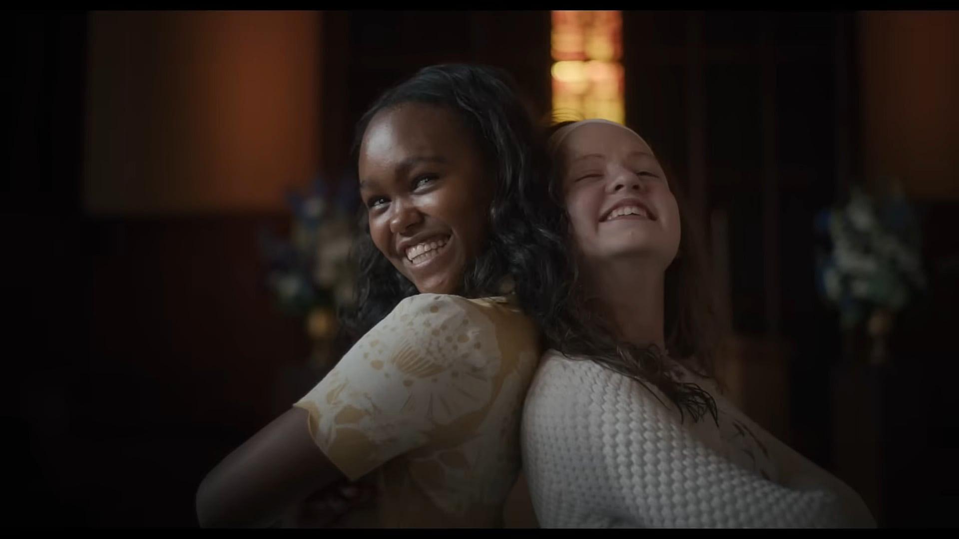 Katherine (Olivia O'Neill) and Angela (Lidya Jewett) pose for a photo in The Exorcist: Believer