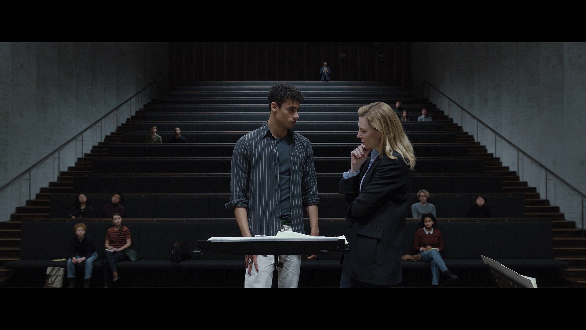 Lydia Tár (Cate Blanchett) takes an interest in Max's (Zethphan Smith-Gneist) work via Tár (2022), Universal Pictures