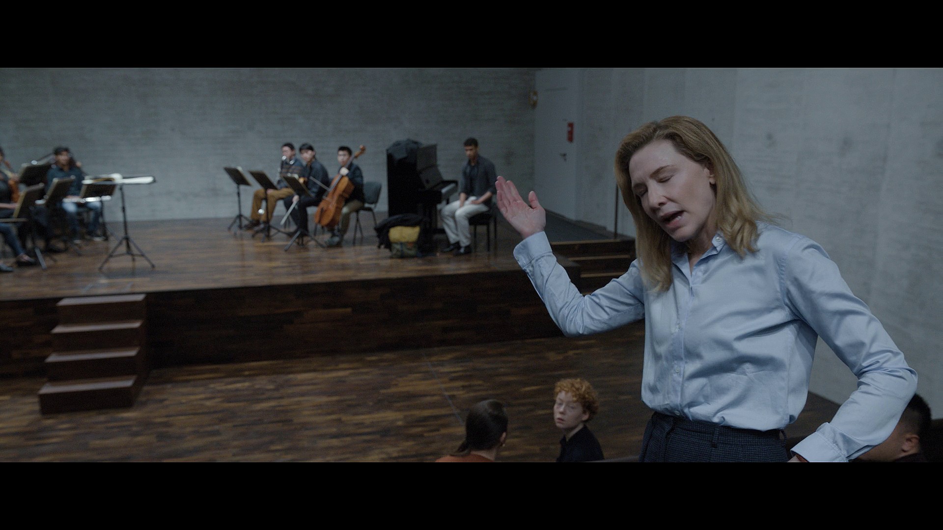 Lydia Tár (Cate Blanchett) calls on her class to use Max's (Zethphan Smith-Gneist) identity politics lens against him via Tár (2022), Universal Pictures