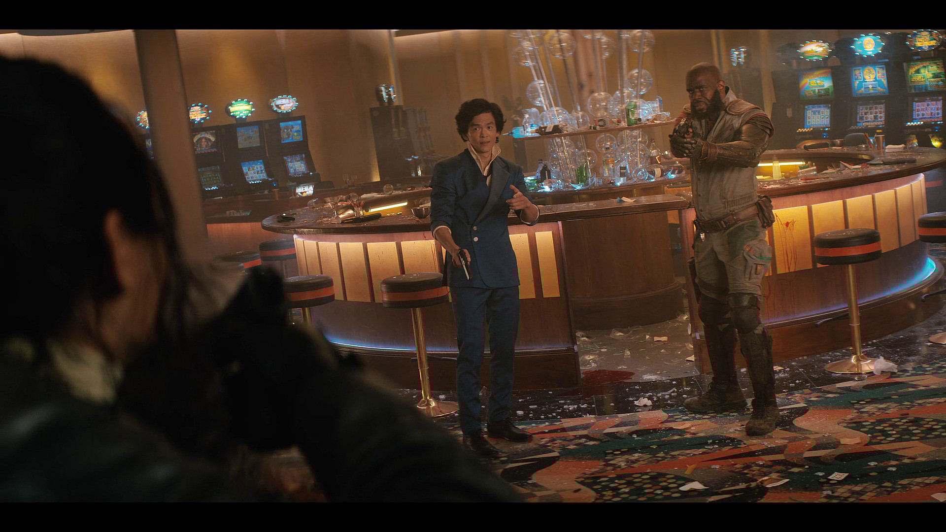 Spike Spiegel (John Cho) and Jet Black (Mustafa Shakir) attempt to stop a casino heist in Cowboy Bebop Season 1 Episode 1 "Cowboy Gospel" (2021), Netflix