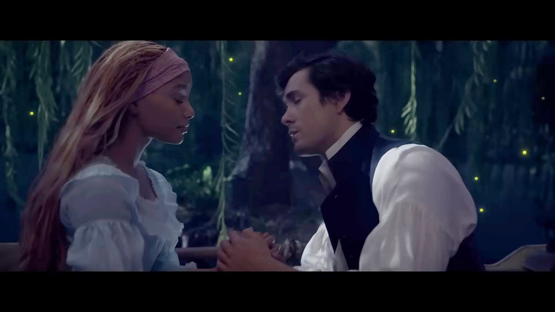 Prince Eric (Jonah Hauer-King) moves in to kiss Ariel (Halle Bailey) in The Little Mermaid (2023), Disney