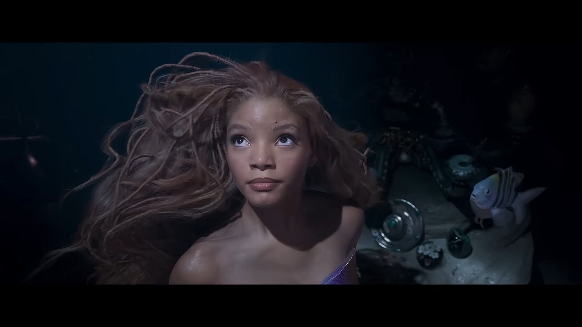 Ariel (Halle Bailey) longs for the surface in The Little Mermaid (2023), Disney