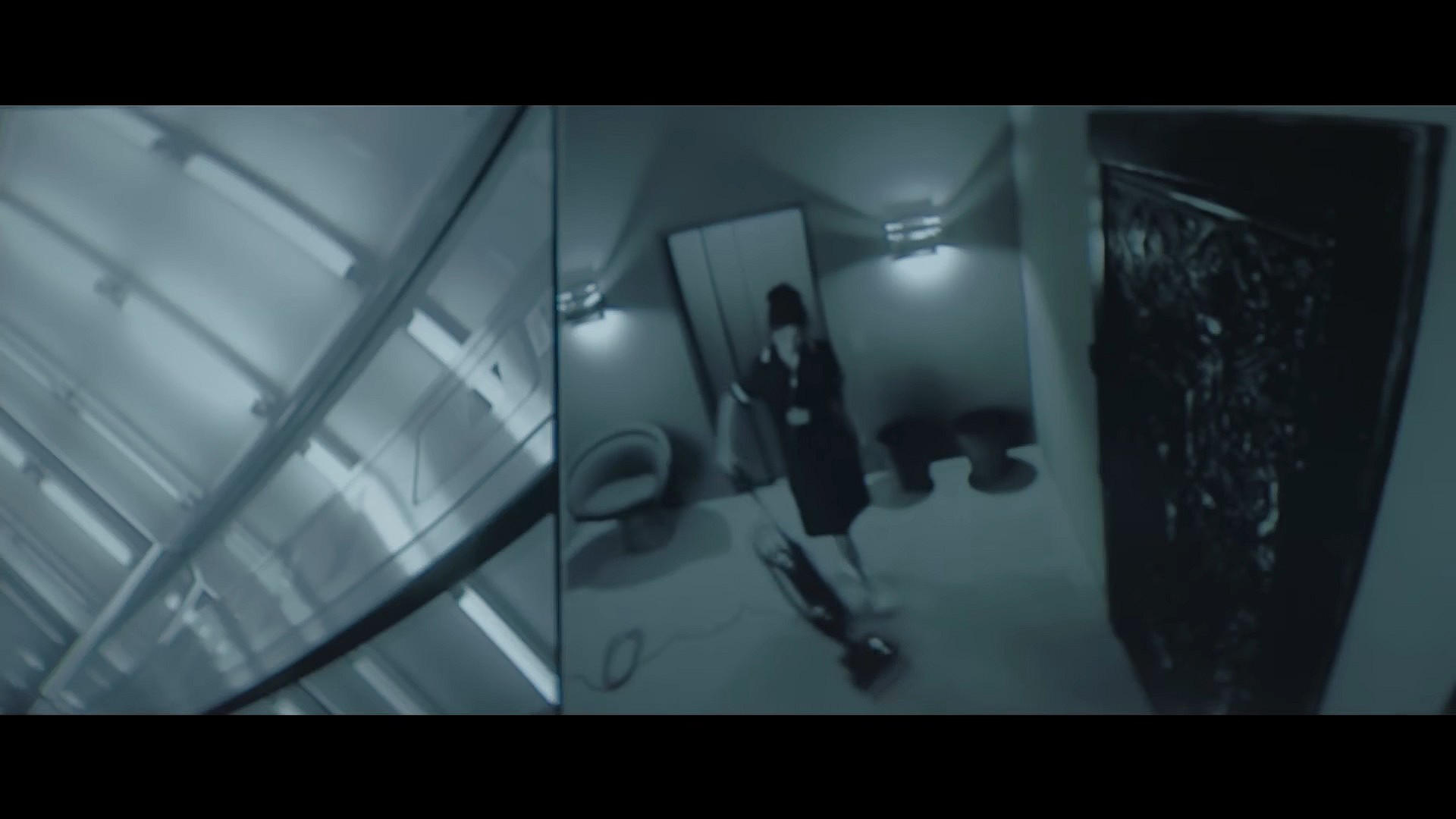 'Jasmine' (Elyza Stuyck) vacuums right outside of Nemo's (Willem Dafoe) prison in Inside (2023), Focus Features