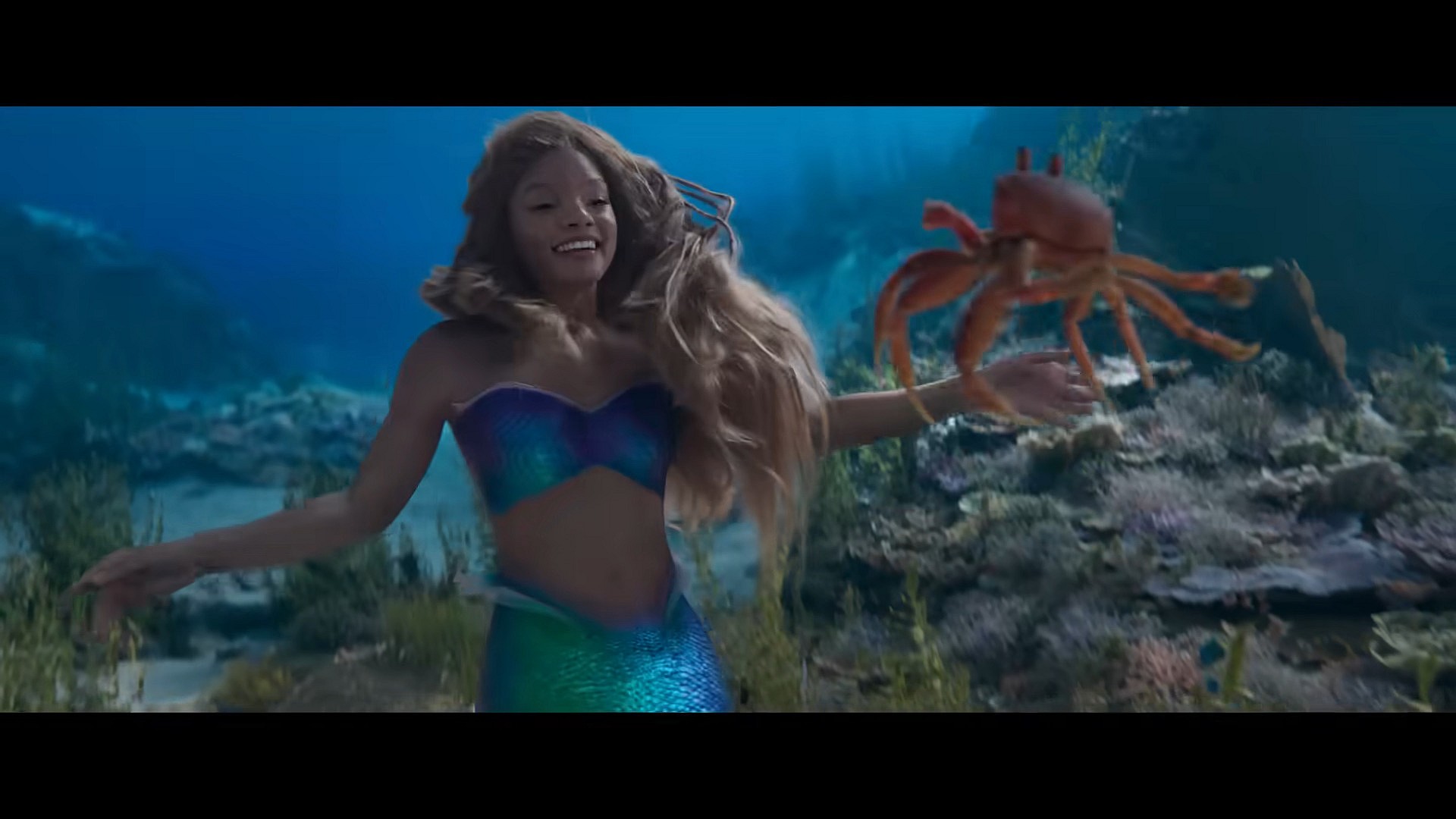 Ariel (Halle Bailey) sings with Sebastian (Daveed Digs) in The Little Mermaid (2023), Walt Disney Studios