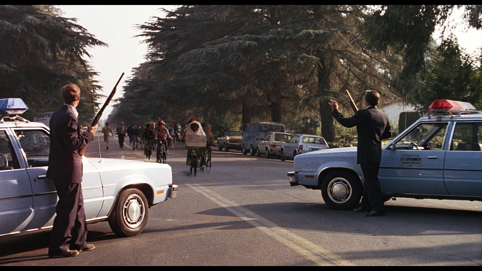 Federal agents attempt to apprehend Elliott (Henry Thomas), E.T. (Pat Welsh/Steven Spielberg/Kayden Green) and their friends in E.T. the Extra-Terrestrial (1982), Universal Pictures