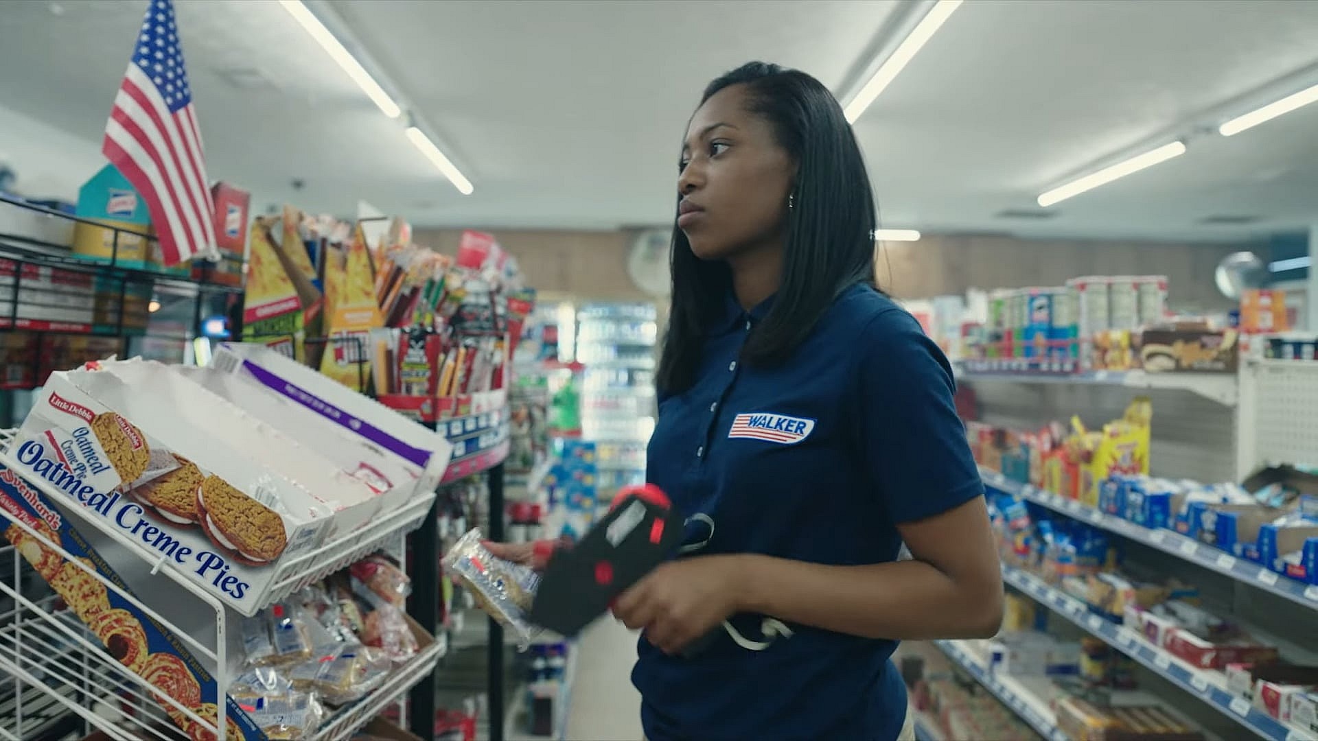 Jodi (Hailey Kilgore) counts the seconds till her shift ends in Cinnamon (2023), Tubi