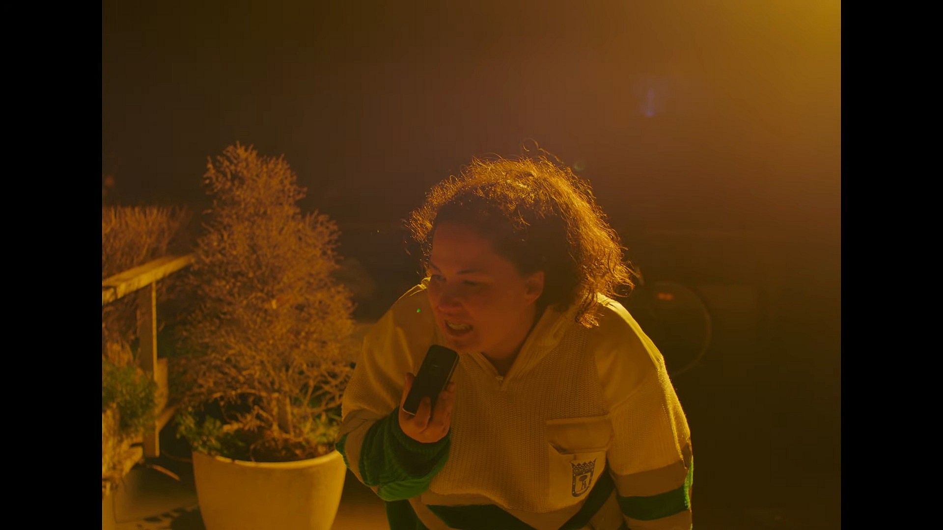 Adela (Laura Galan) makes a call to a public radio station in One Night with Adela (2023), ConUnPack