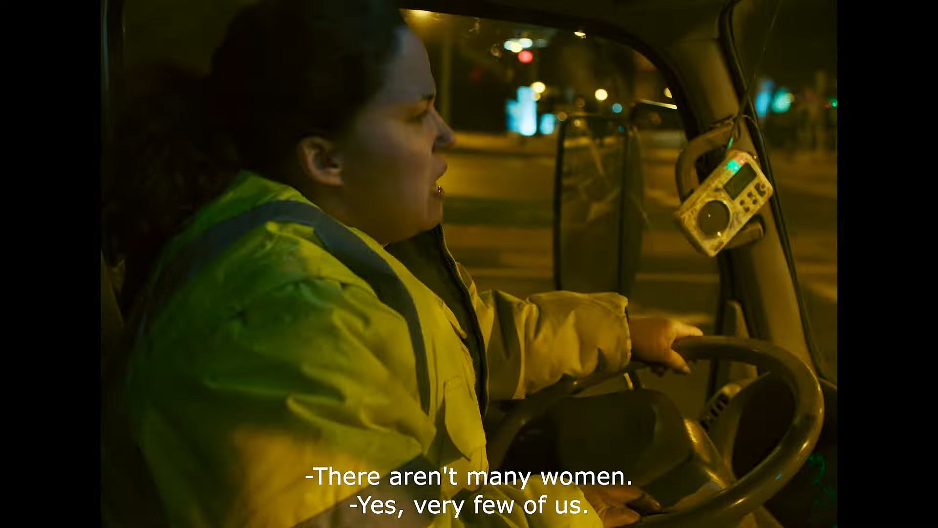 Adela (Laura Galan) explains her job to the radio DJ in One Night with Adela (2023), ConUnPack