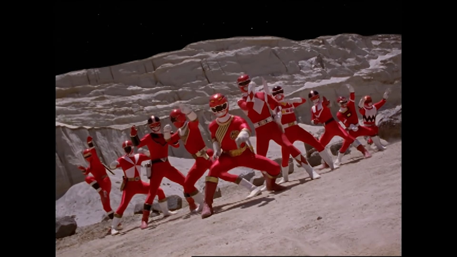 The Red Rangers prepare for battle in Power Rangers Wild Force Episode 34 "Forever Red" (2002), Hasbro (Footage originally from Gaoranger vs. Super Sentai, Forever Red (2001), Toei Co. Ltd.)