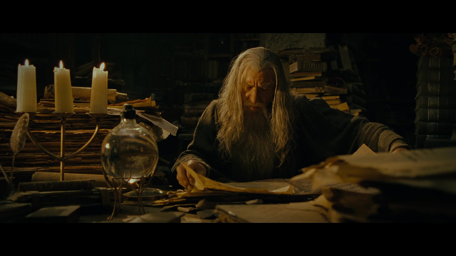 Gandalf (Sir Ian McKellen) researches the true nature of the One Ring in The Lord of the Rings: The Fellowship of the Ring (2001), New Line Cinema