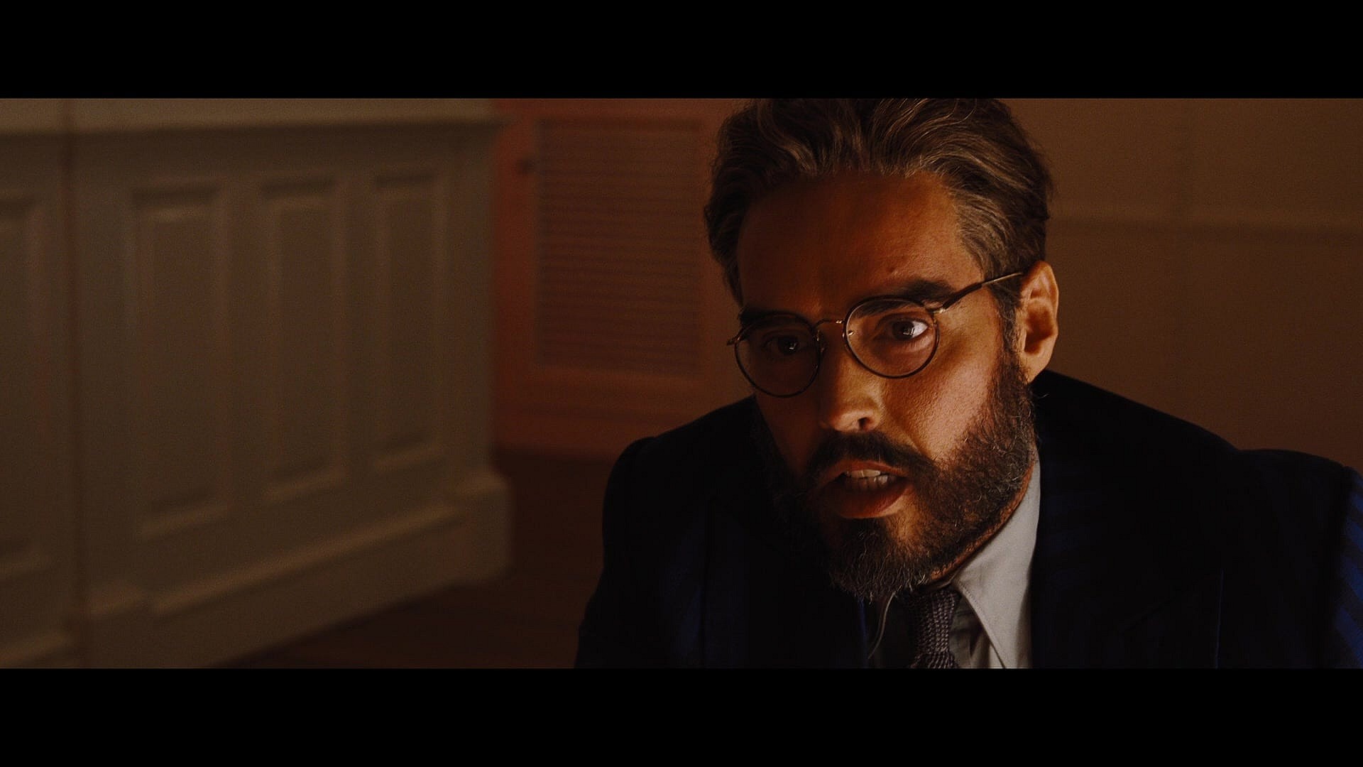 Dr. Windlesham (Russell Brand) has questions for Inspector Poirot (Kenneth Branagh) in Death on the Nile (2022), 20th Century Studios