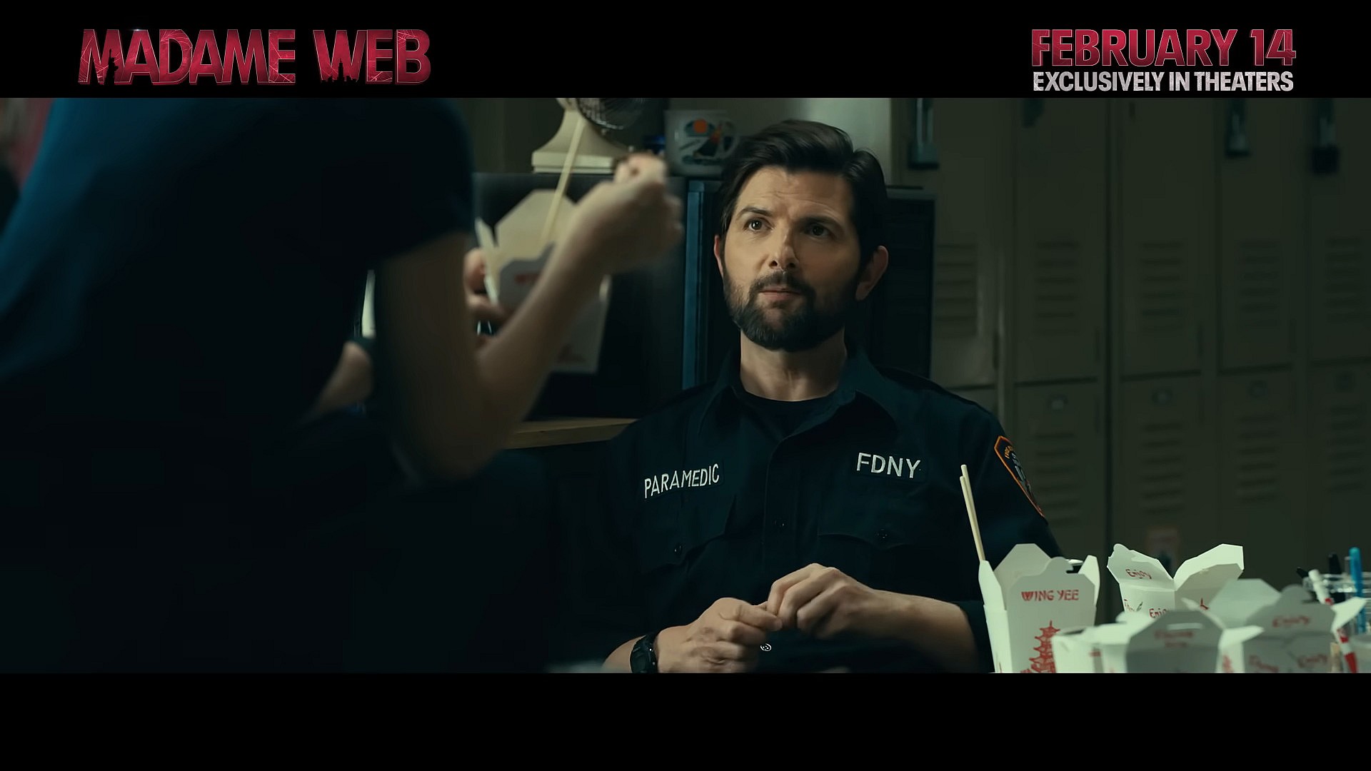 A supposed Uncle Ben (Adam Scott) and Cassie (Dakota Johnson) take their lunch break in Madame Web (2024), Sony