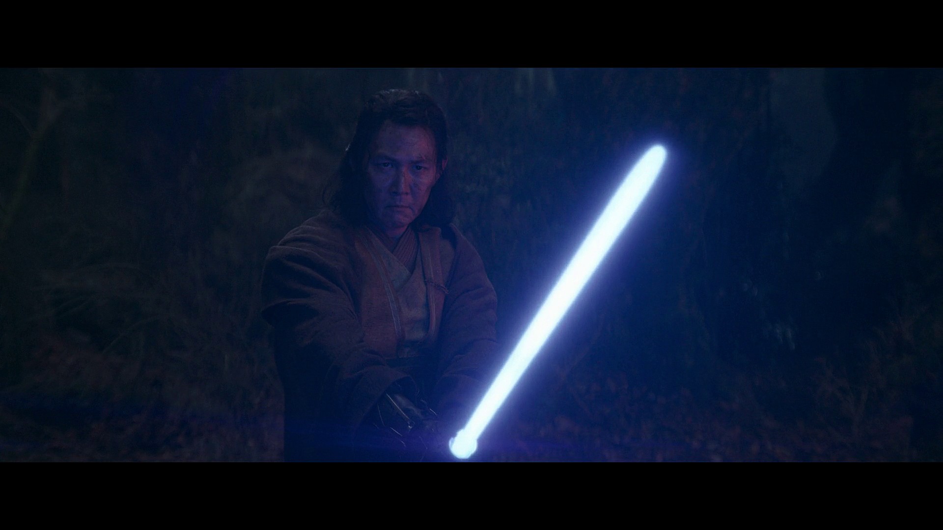 Master Sol (Lee Jung-jae) draws his lightsaber against The Stranger (Manny Jacinto) in The Acolyte Season 1 Episode 5 "Night" (2024), Disney
