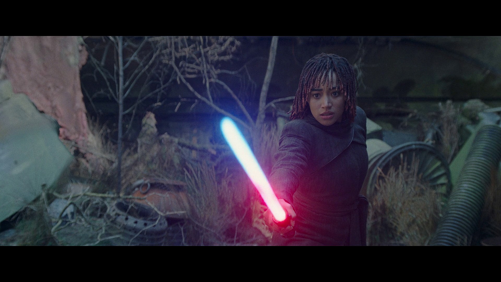 Osha (Amandla Stenberg) watches on as she begins Bleeding Master Sol's (Lee Jung-jae) lightsaber in The Acolyte Season 1 Episode 8 "The Acolyte" (2024), Disney