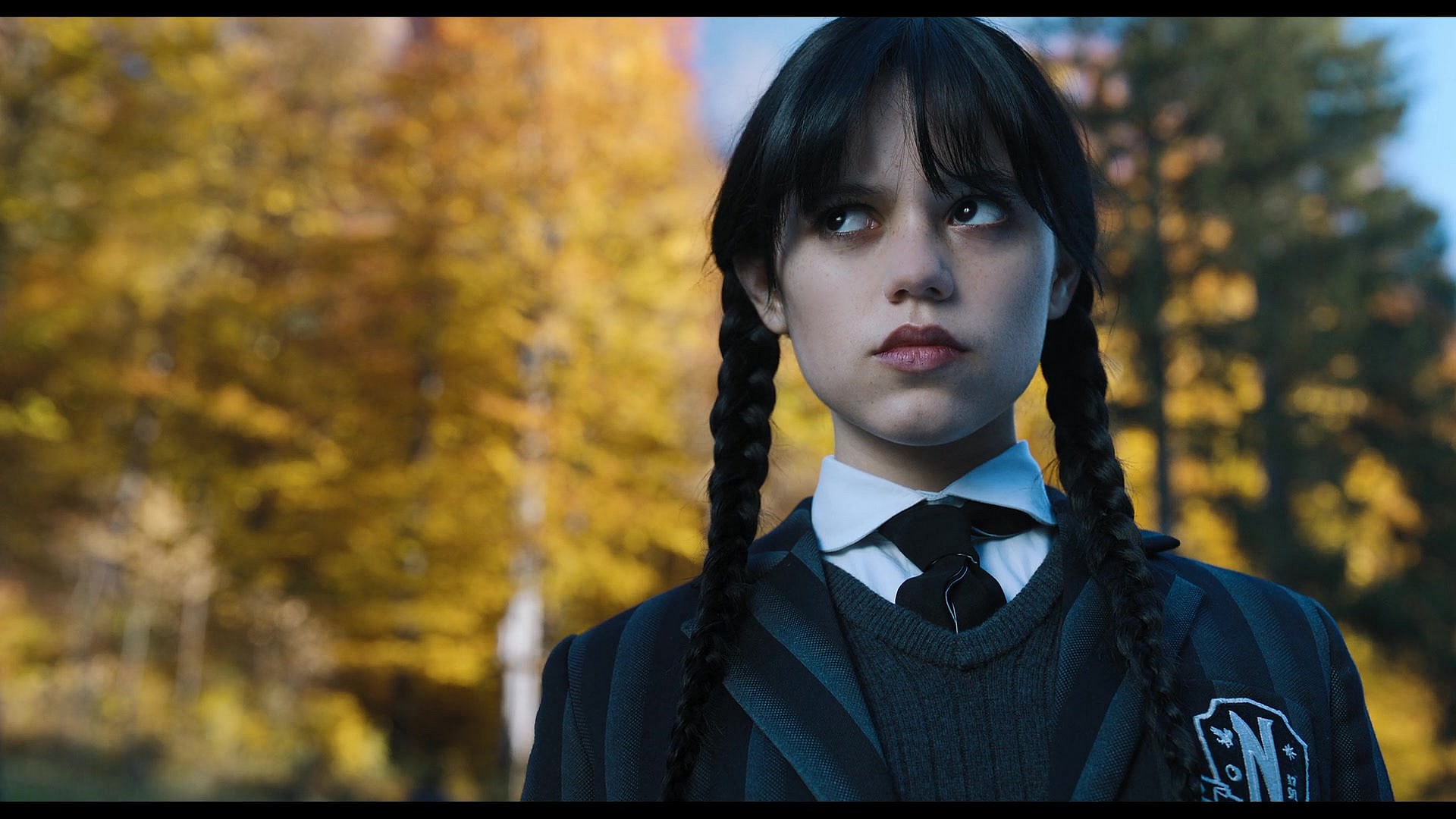 Wednesday (Jenna Ortega) rolls her eyes at Enid's (Emma Myers) school spirit in Wednesday Season 1 Episode 2 "Woe Is The Loneliest Number" (2022), Netflix