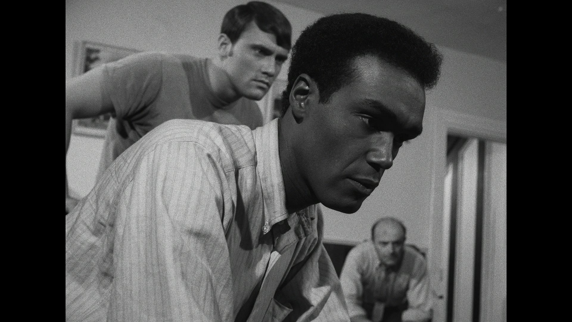 Ben (Duane Jones), Tom (Keith Wayne), and Harry (Karl Hardman) tune in to a news update in Night of the Living Dead (1968), Continental Distributing