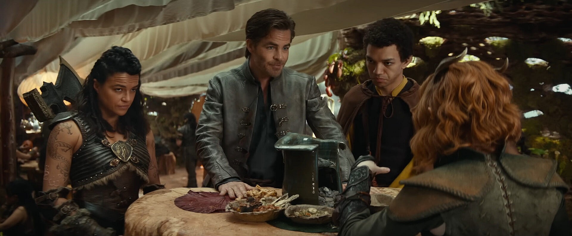 Edgin the Bard (Chris Pine) attempts to reassure Holga the Barbarian (Michelle Rodriguez), Simon the Sorcerer (Justice Smith), and Doric the Druid (Sophia Lillis) of his leadership skills in Dungeons & Dragons: Honor Among Thieves (2023), Paramount Pictures via YouTube