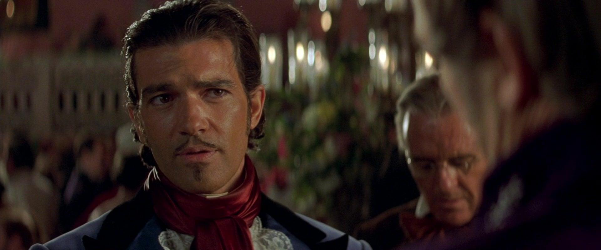 Alejandro Murrieta (Antonio Banderas) poses as  Don Alejandro del Castillo y García in order to infiltrate the home of Don Rafael Montero (Stuart Wilson) in The Mask of Zorro (1998), Sony Pictures via Blu-ray
