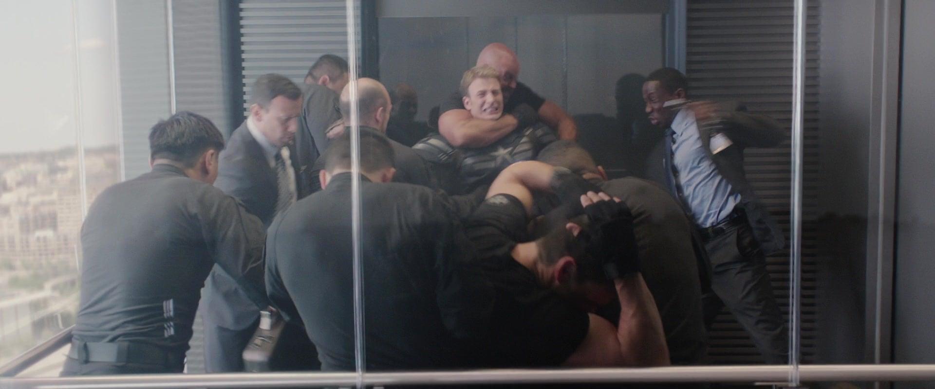 Steve Rogers (Chris Evans) is accosted by Hydra's sleeper agents within S.H.I.E.L.D. in Captain America: The Winter Soldier (2014), Marvel Entertainment